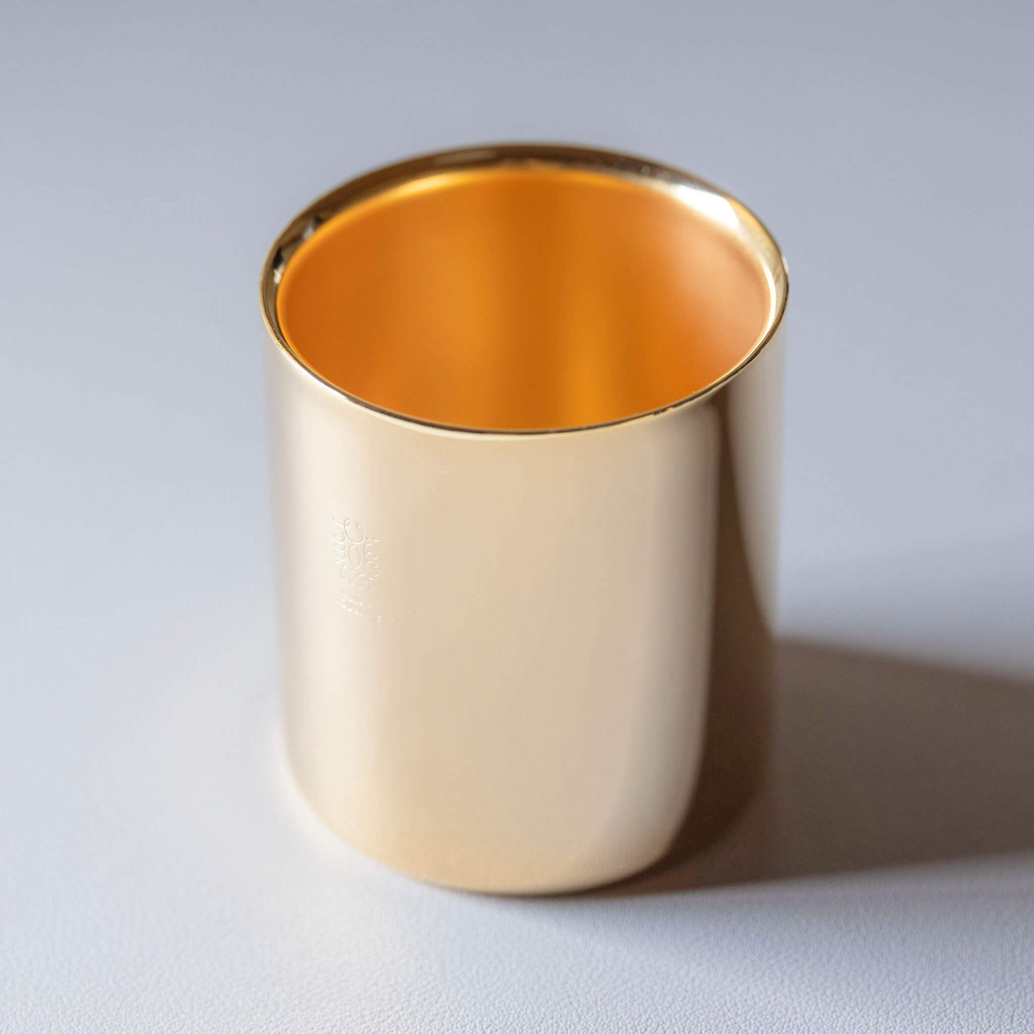 Front view of the 24K gold-plated 18-8 stainless steel insulated coffee and tea cup on a clean background.