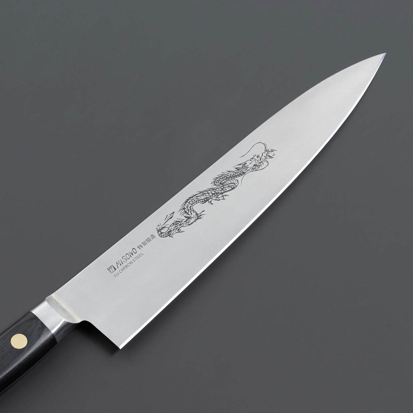 Close-up of the dragon engraving on a Misono Swedish carbon steel gyuto knife