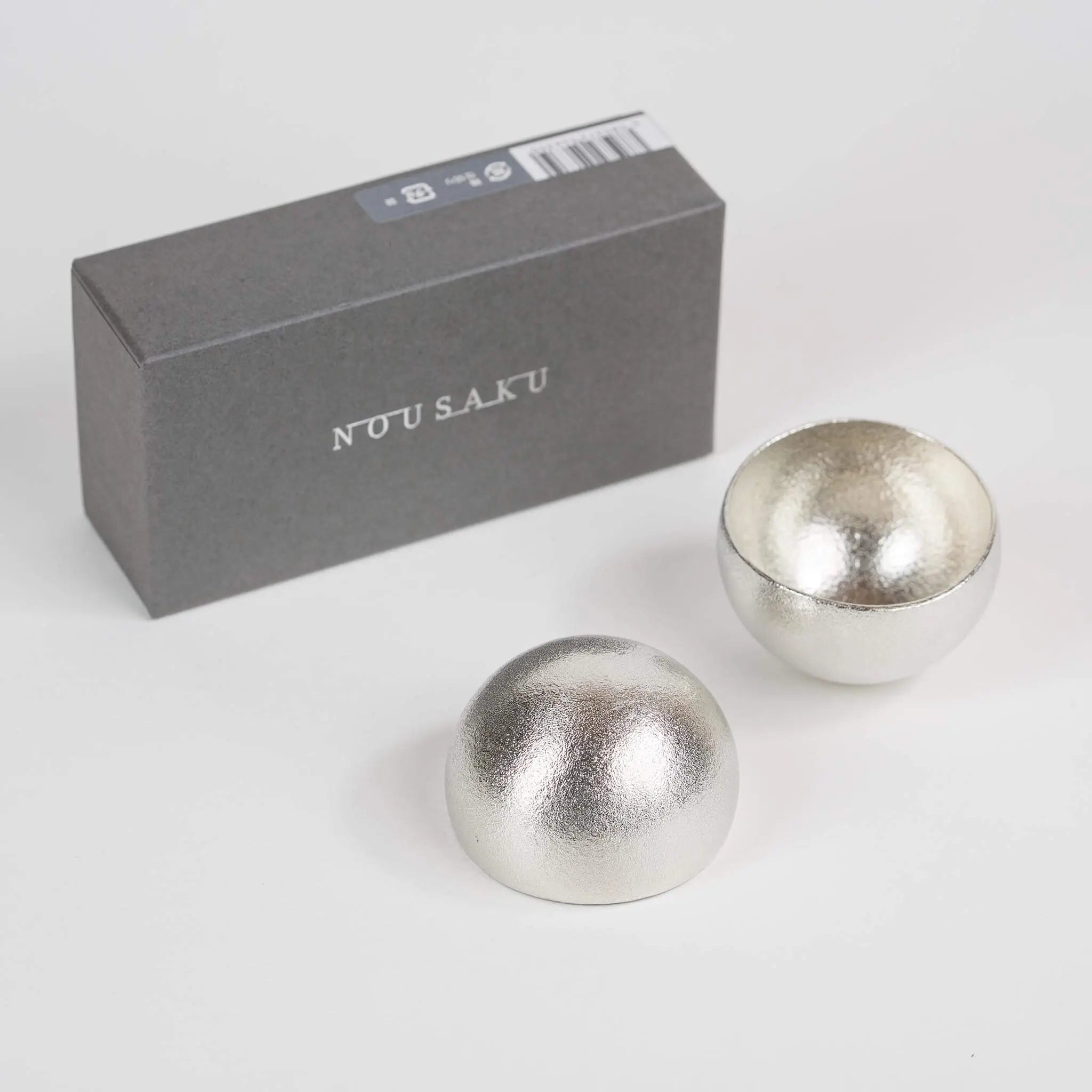 Artistic top view of the rocking sake cups stacked together, showcasing their organic, hand-formed shapes.