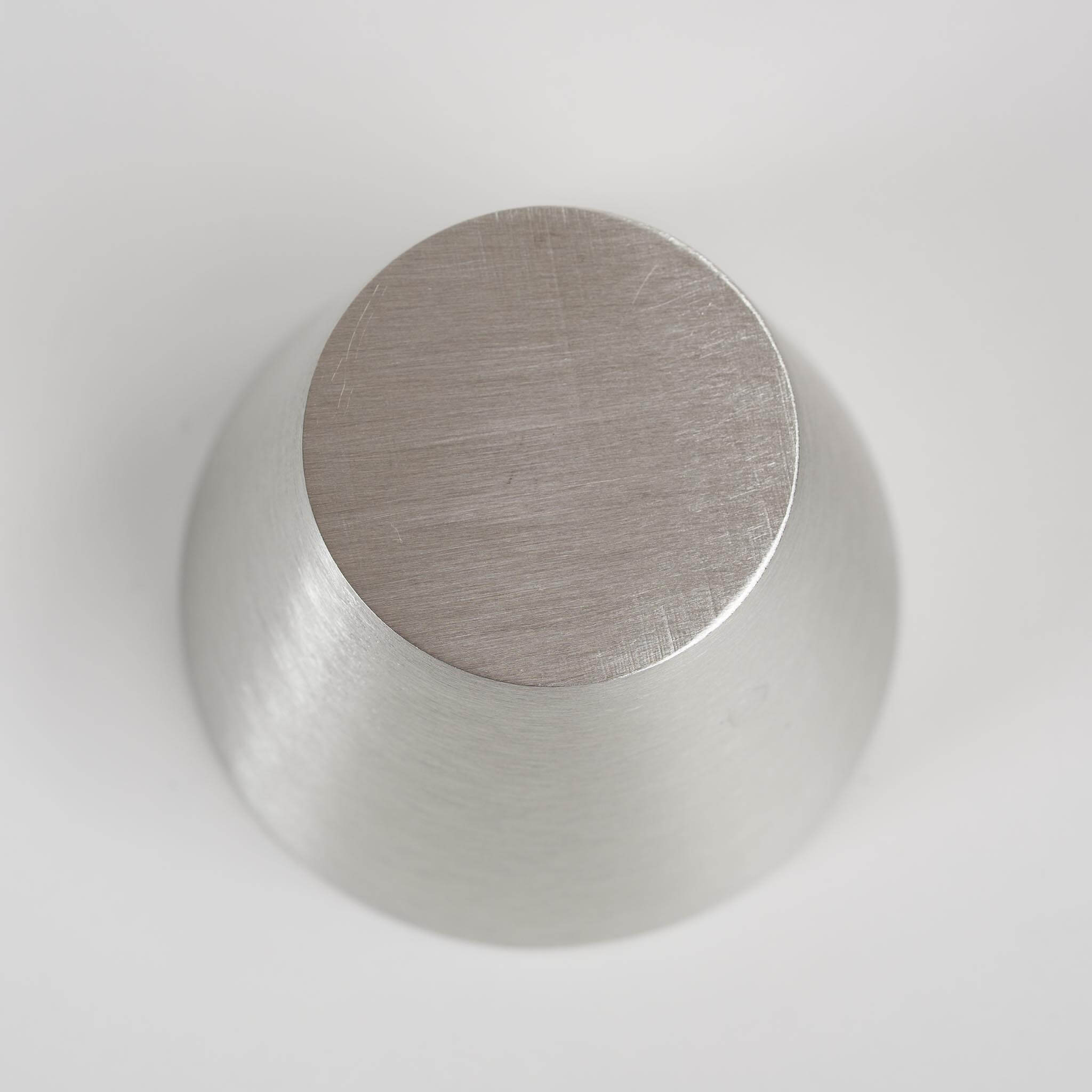 Bottom view of the authentic Nousaku tin cup showing the brand craftsmanship.