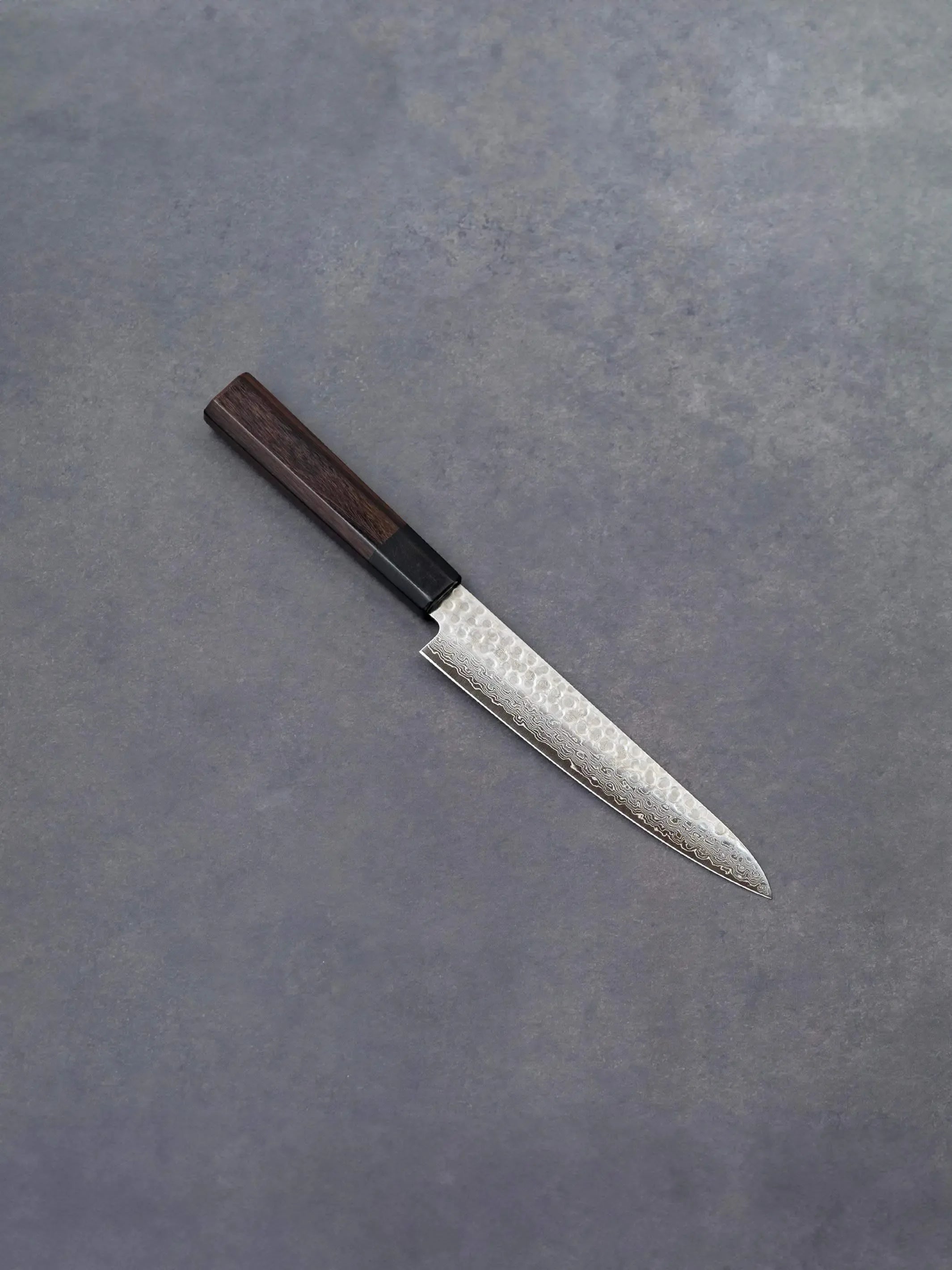 150mm Damascus petty knife with AUS-10 high-carbon steel blade and solid wood handle, crafted by Fujikan in Japan.