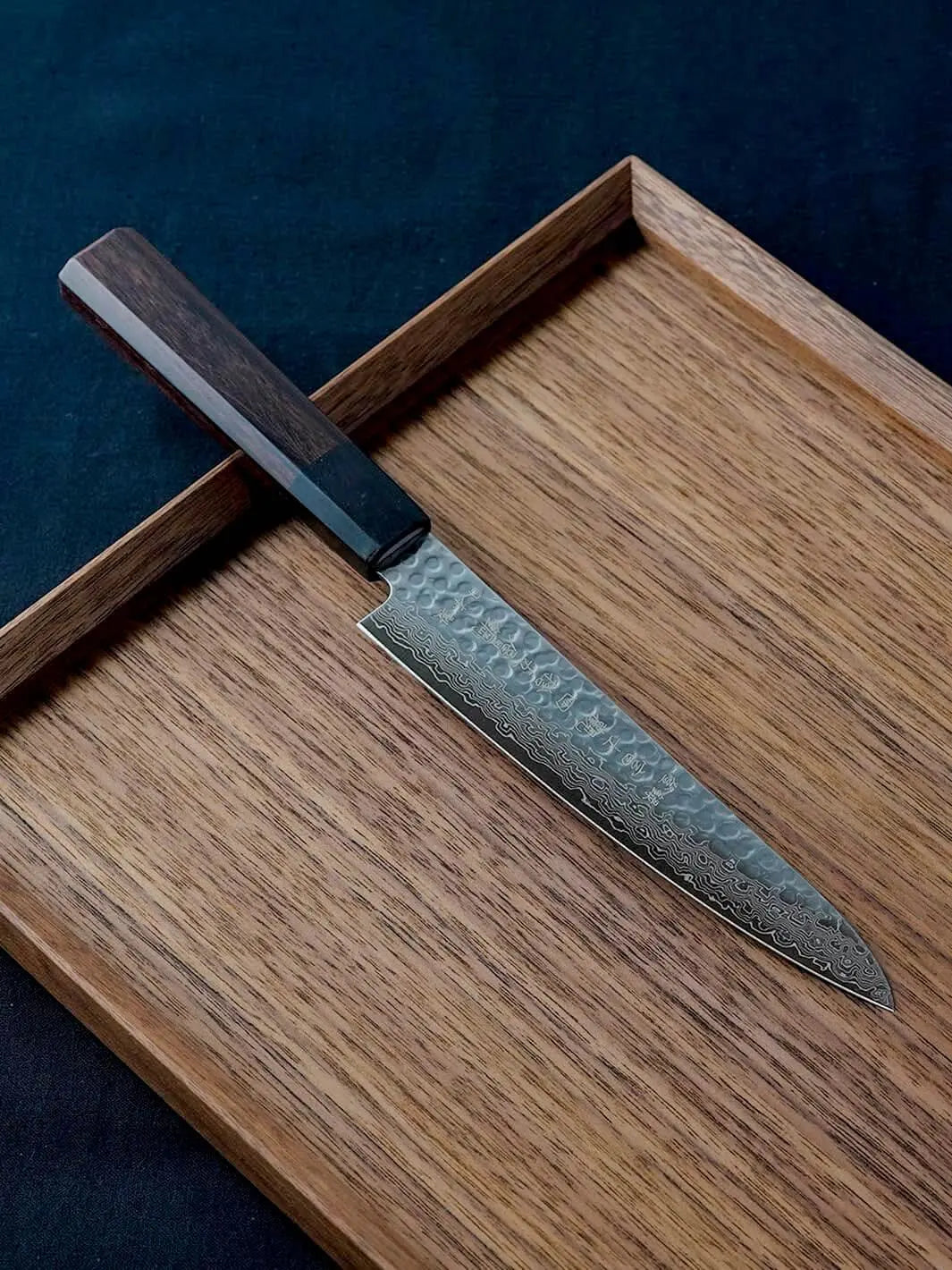 150mm Damascus petty knife with AUS-10 high-carbon steel blade and solid wood handle, crafted by Fujikan in Japan.