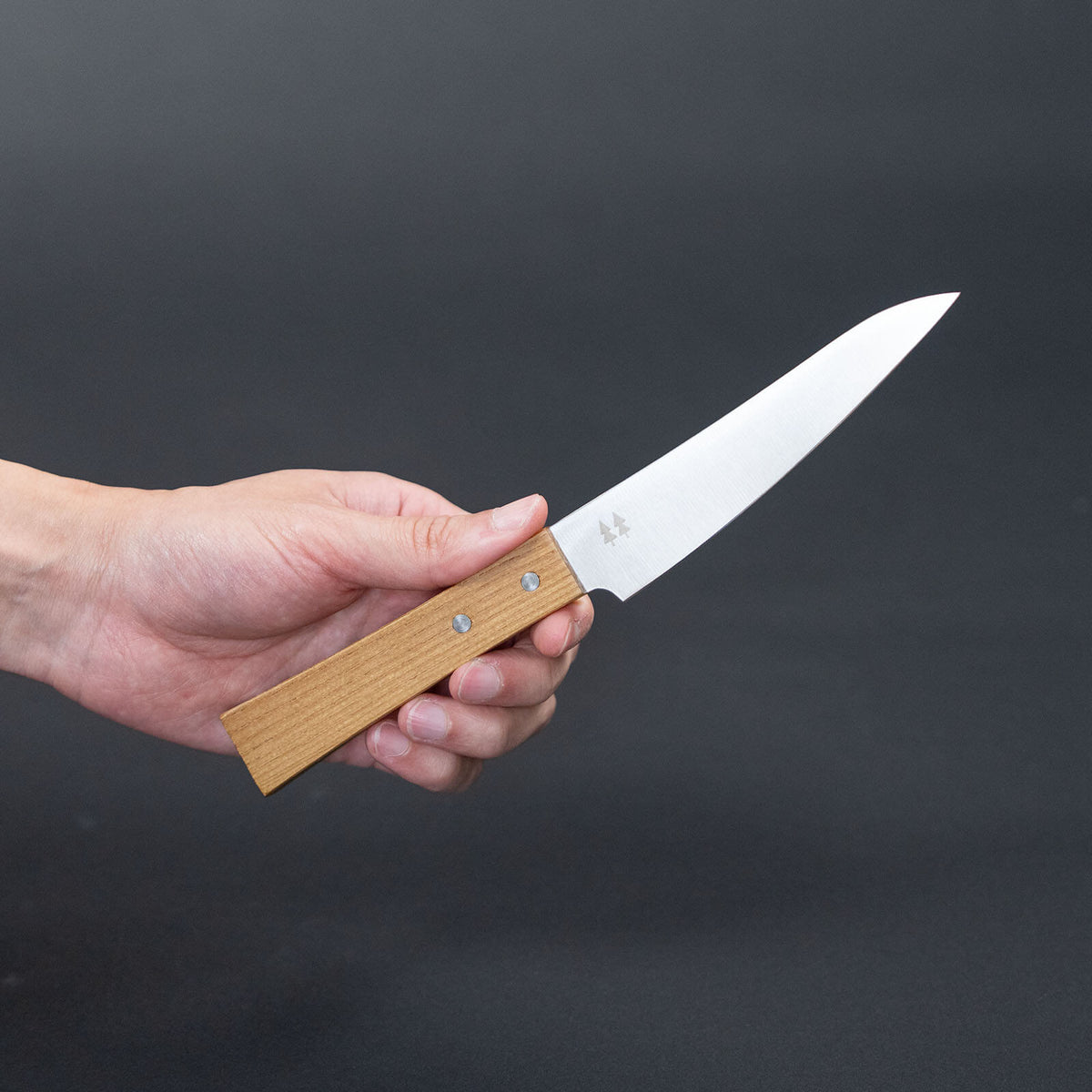 Shizuhamono Morinoki 4.7-inch petty knife held at an angle, showing the blade and keyaki wood handle