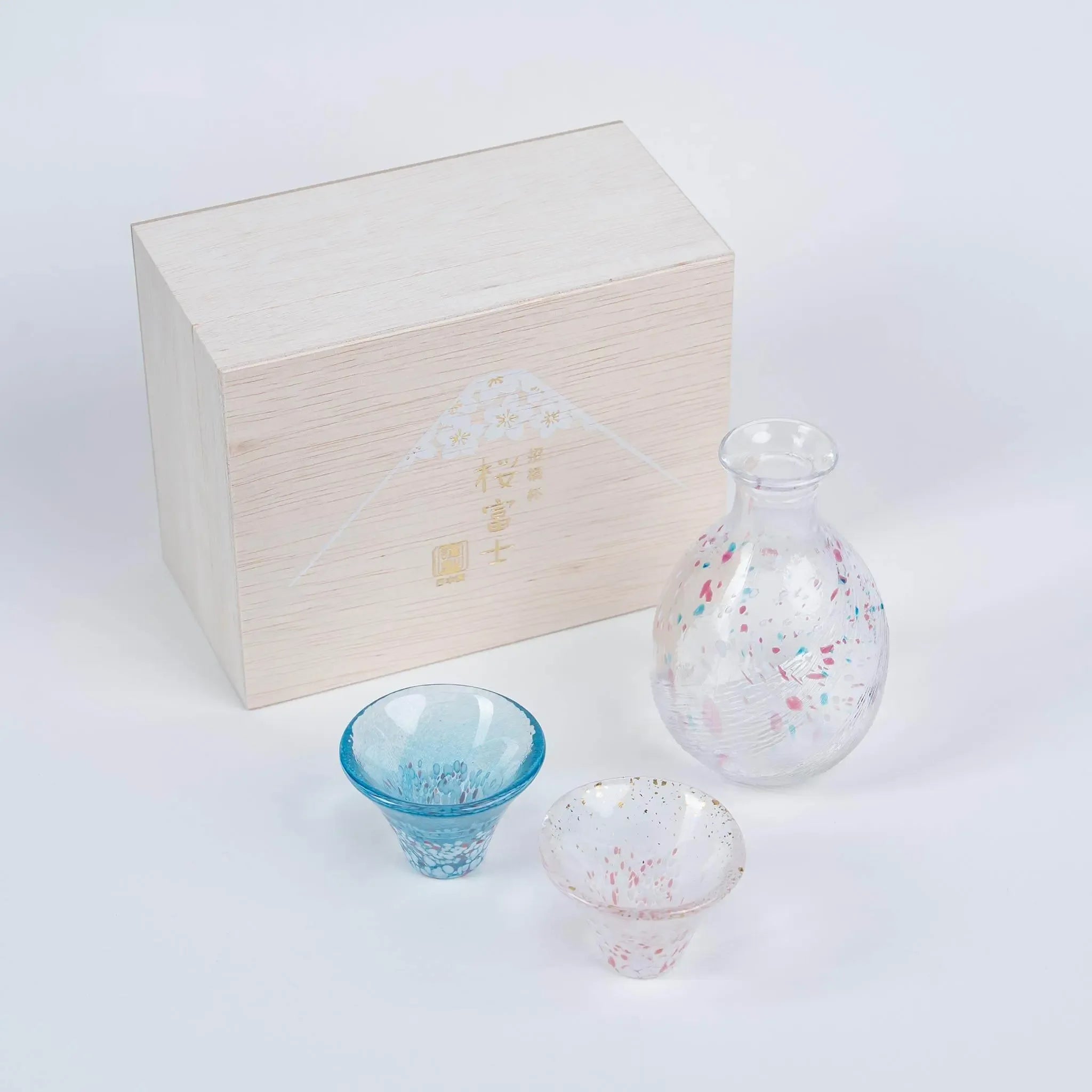 Japanese sakura and Mount Fuji sake set in elegant gift box, handmade glassware perfect for gifting.