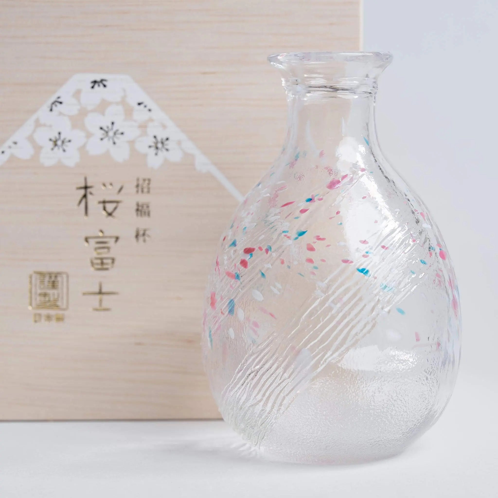 Handmade Japanese sake bottle with sakura and Mount Fuji motif, elegant glass design made in Japan.