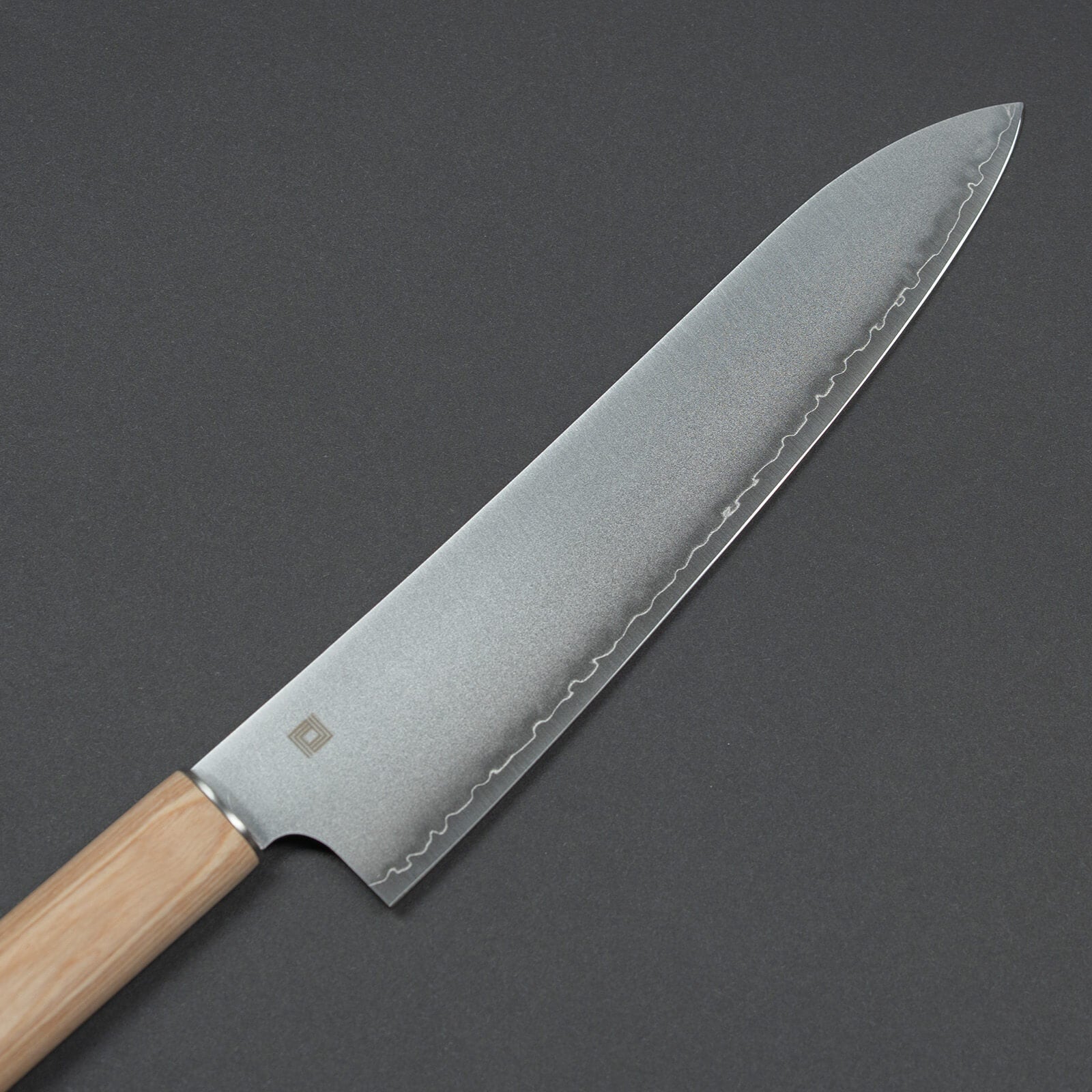 Close-up of 3-layer high-carbon steel blade with engraved logo