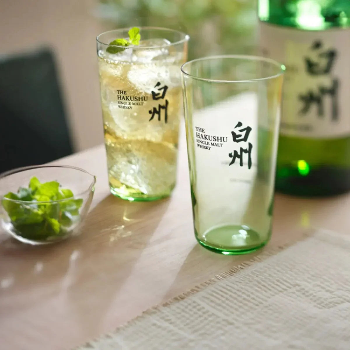 Suntory Hakushu Thin-Walled Tumbler on a table, showing whiskey filled inside