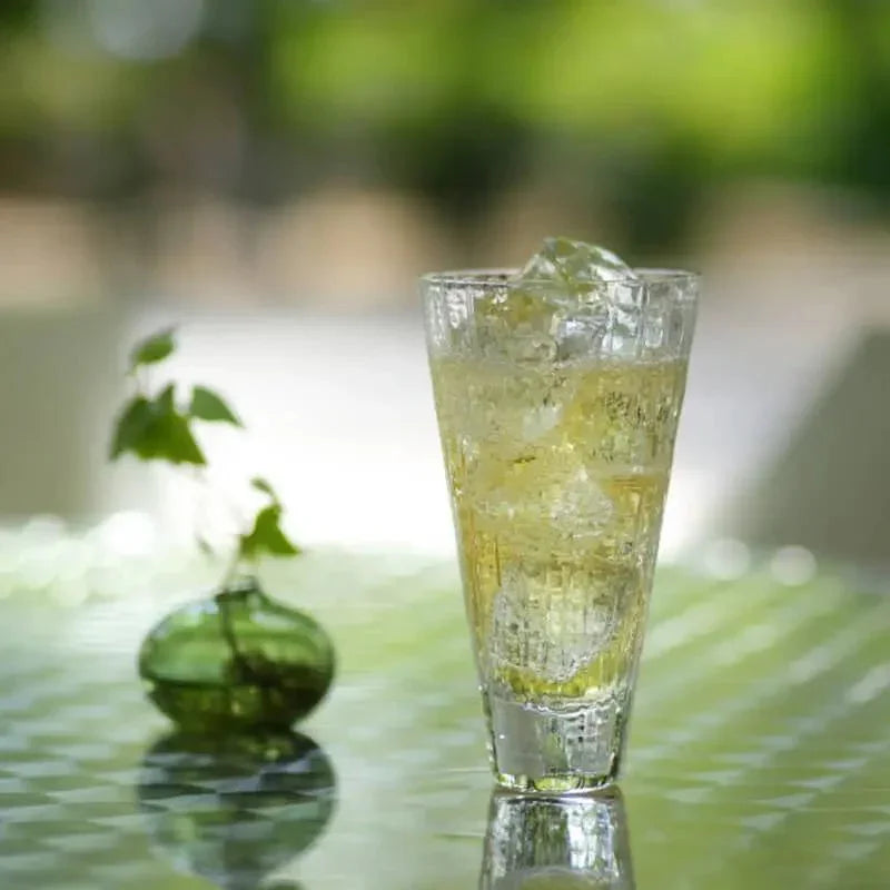 side view of suntory x sghr crafe whiskey glass with whiskey and ice