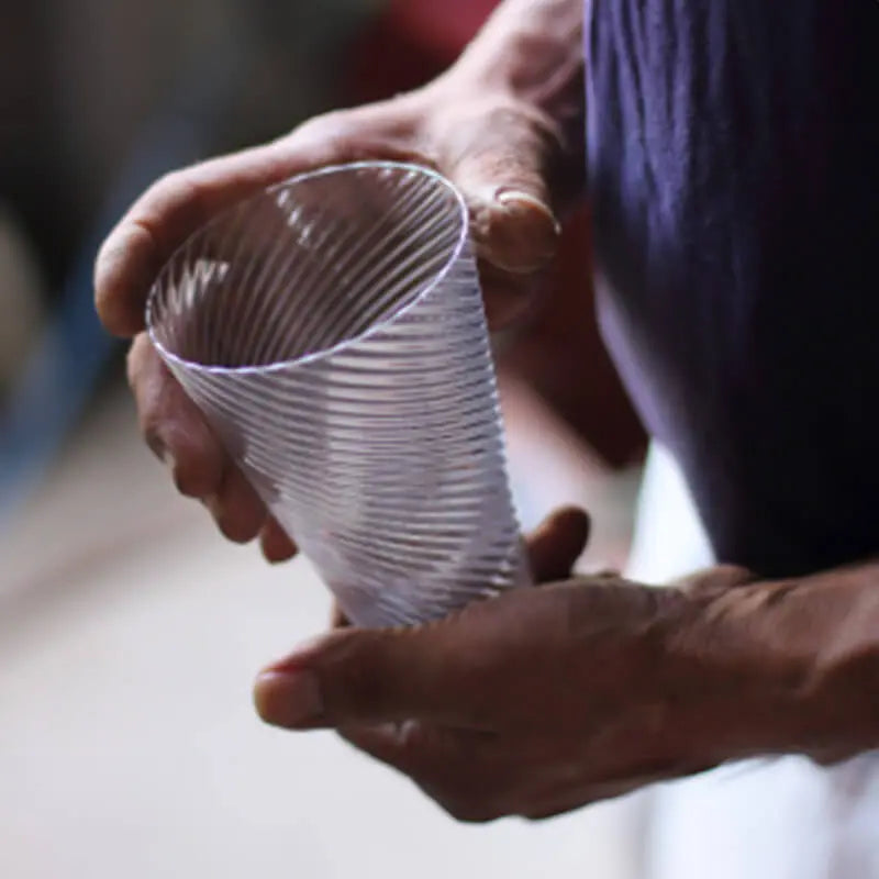 artisan holding suntory x sghr handmade spiral whiskey glass