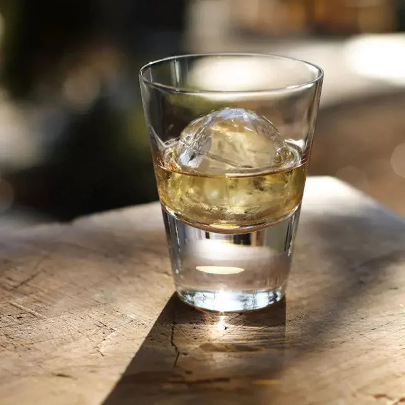 top view of suntory x sghr tsukimi rock glass with whiskey and ice ball