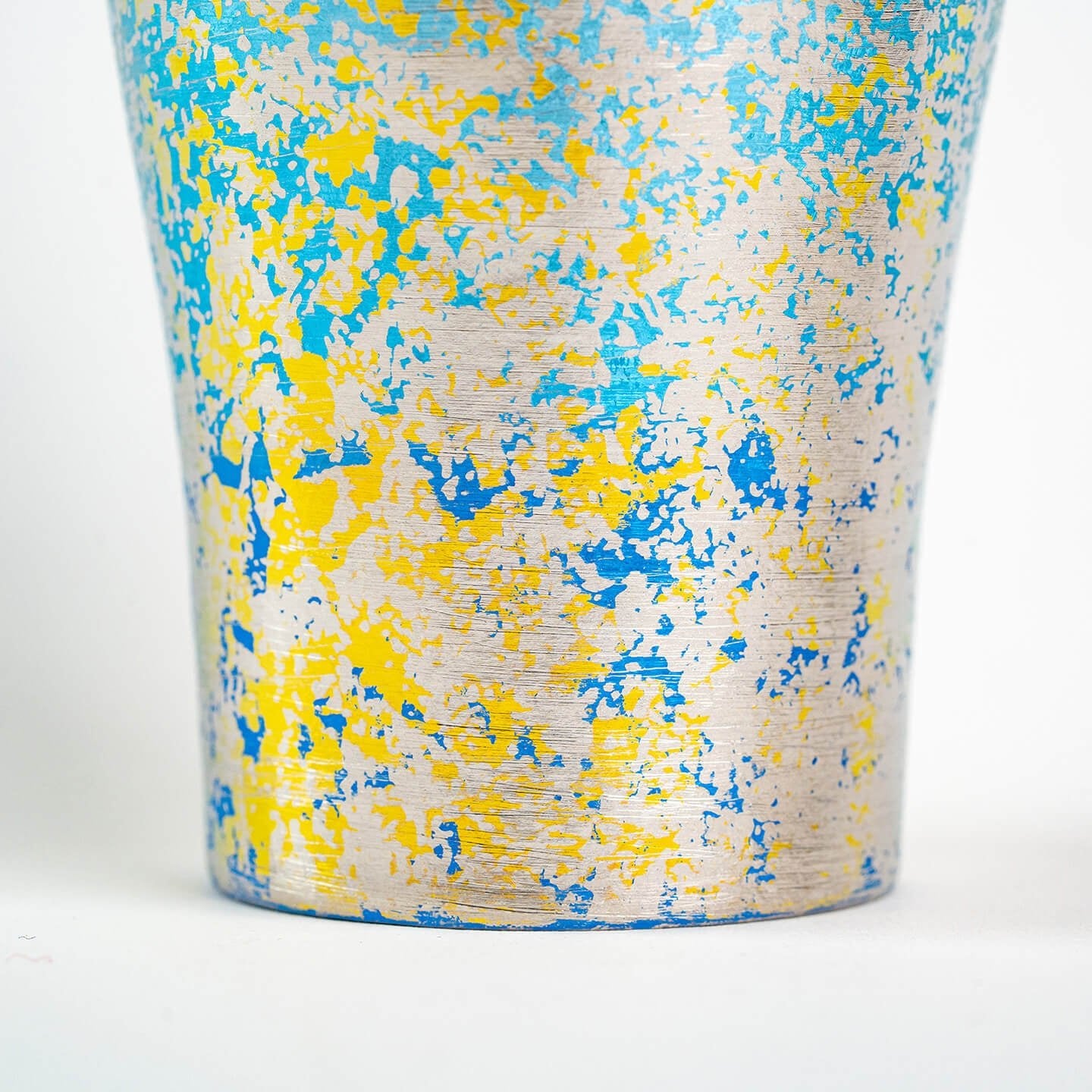 Close-up of lower surface texture on blue titanium tumbler