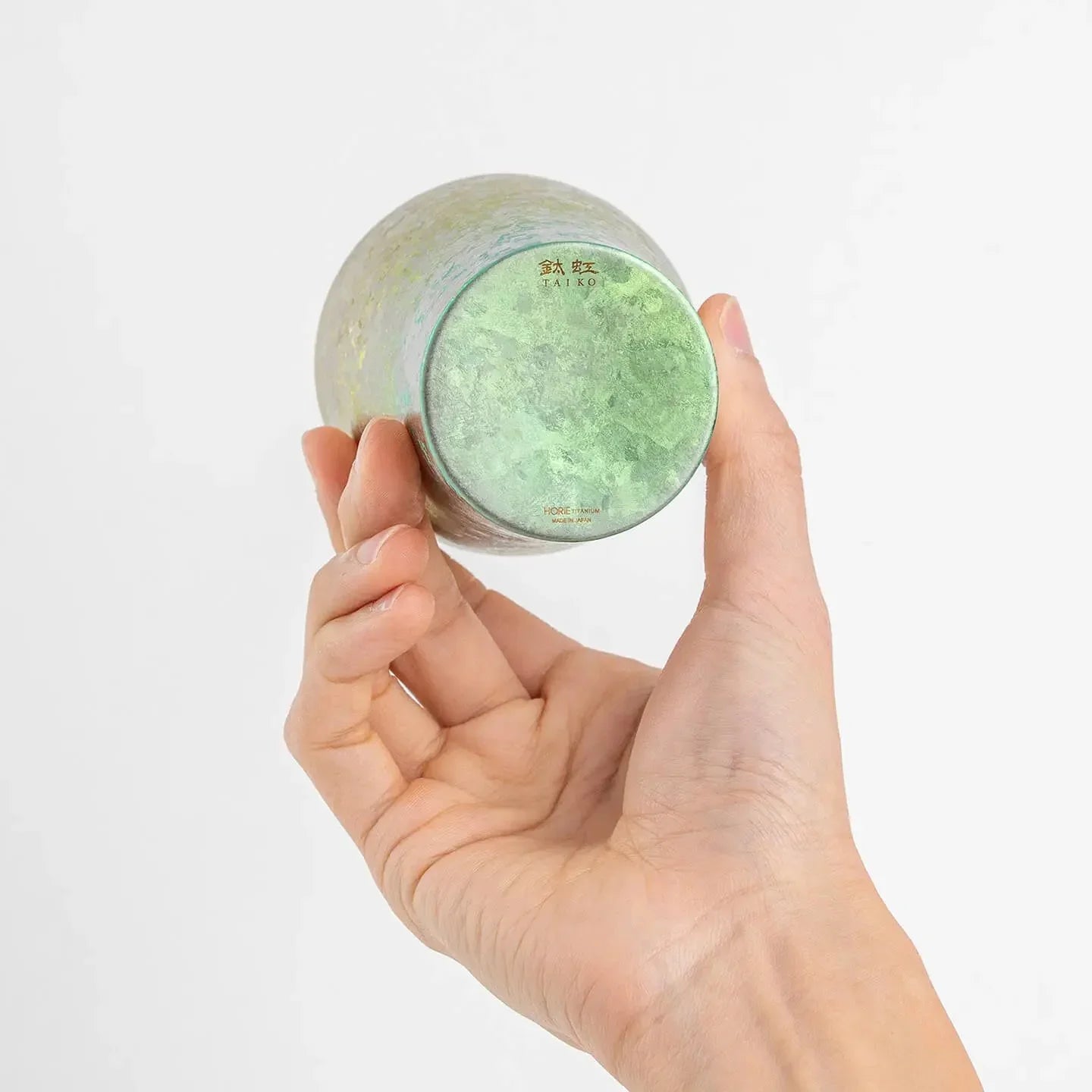 Bottom of pink titanium tumbler displayed in hand