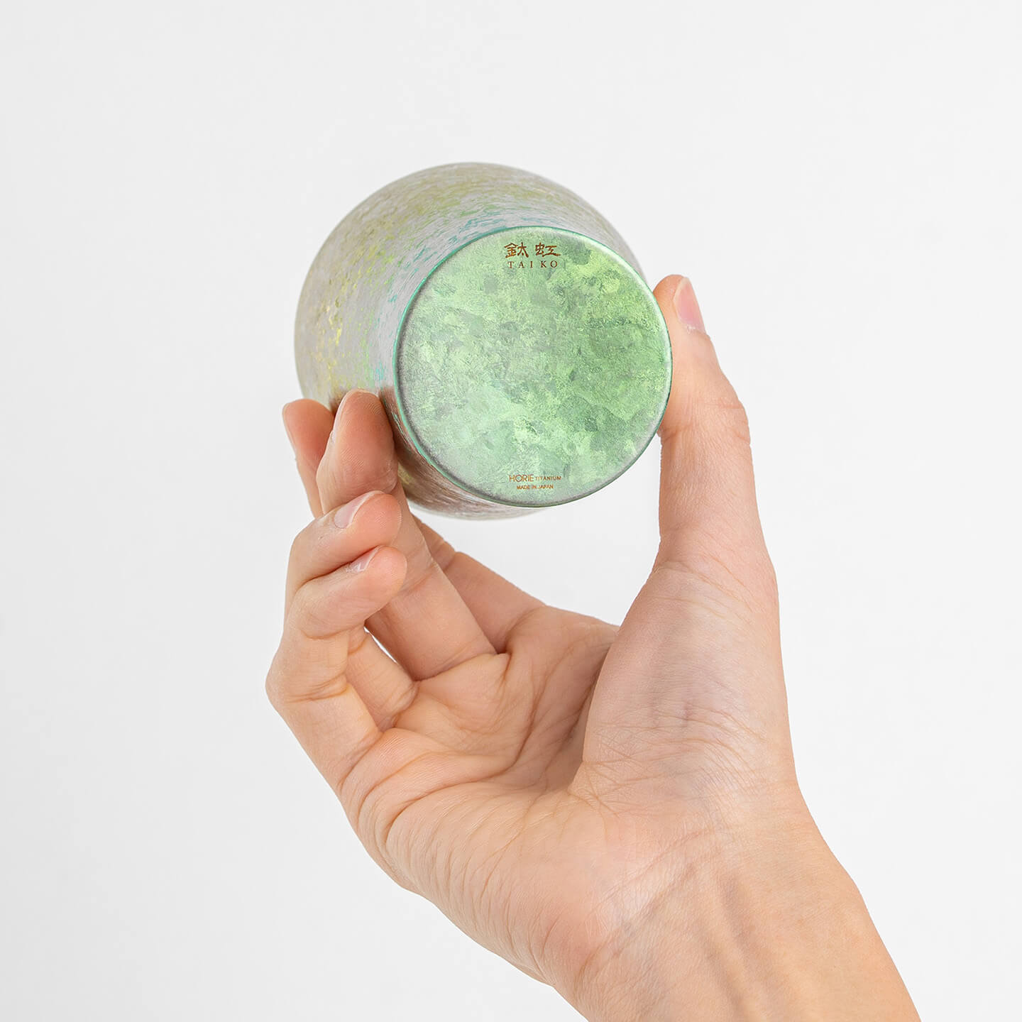 Bottom of pink titanium tumbler displayed in hand