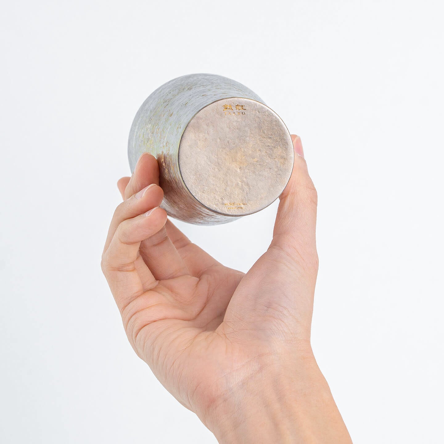 Close-up of the tumbler's bottom, showing the "Taiko" logo and silver texture.