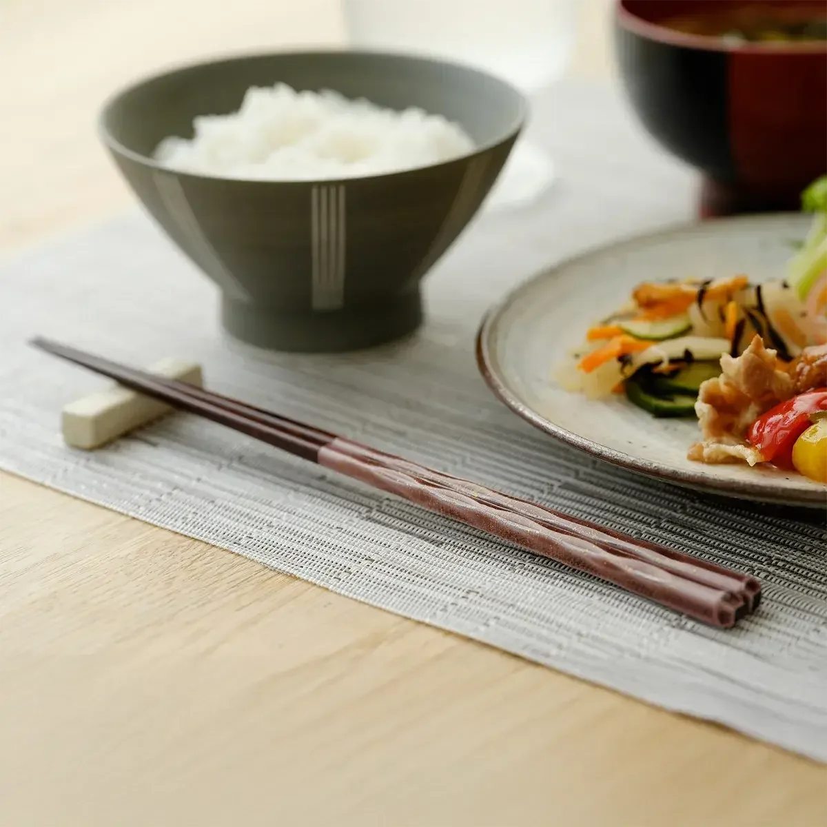 Wakasa lacquer chopsticks placed neatly on a dining table, ready for a meal.