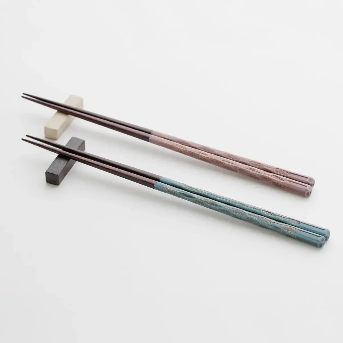 A pair of Wakasa lacquer chopsticks resting elegantly on a chopstick holder.