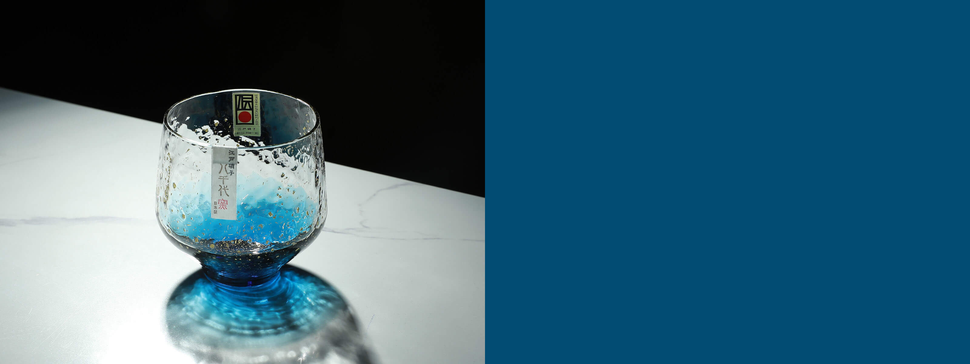 Exquisite Yachiyo Japanese glass sake cup with unique hammered texture and a beautiful blue gradient. Showcasing traditional Japanese glass craftsmanship and modern aesthetics.
