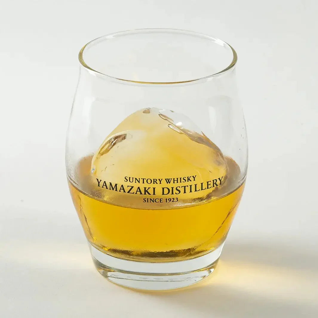 Angled view of Yamazaki ice ball whiskey glass with whisky and ice