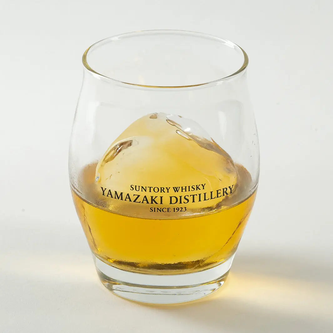 Angled view of Yamazaki ice ball whiskey glass with whisky and ice