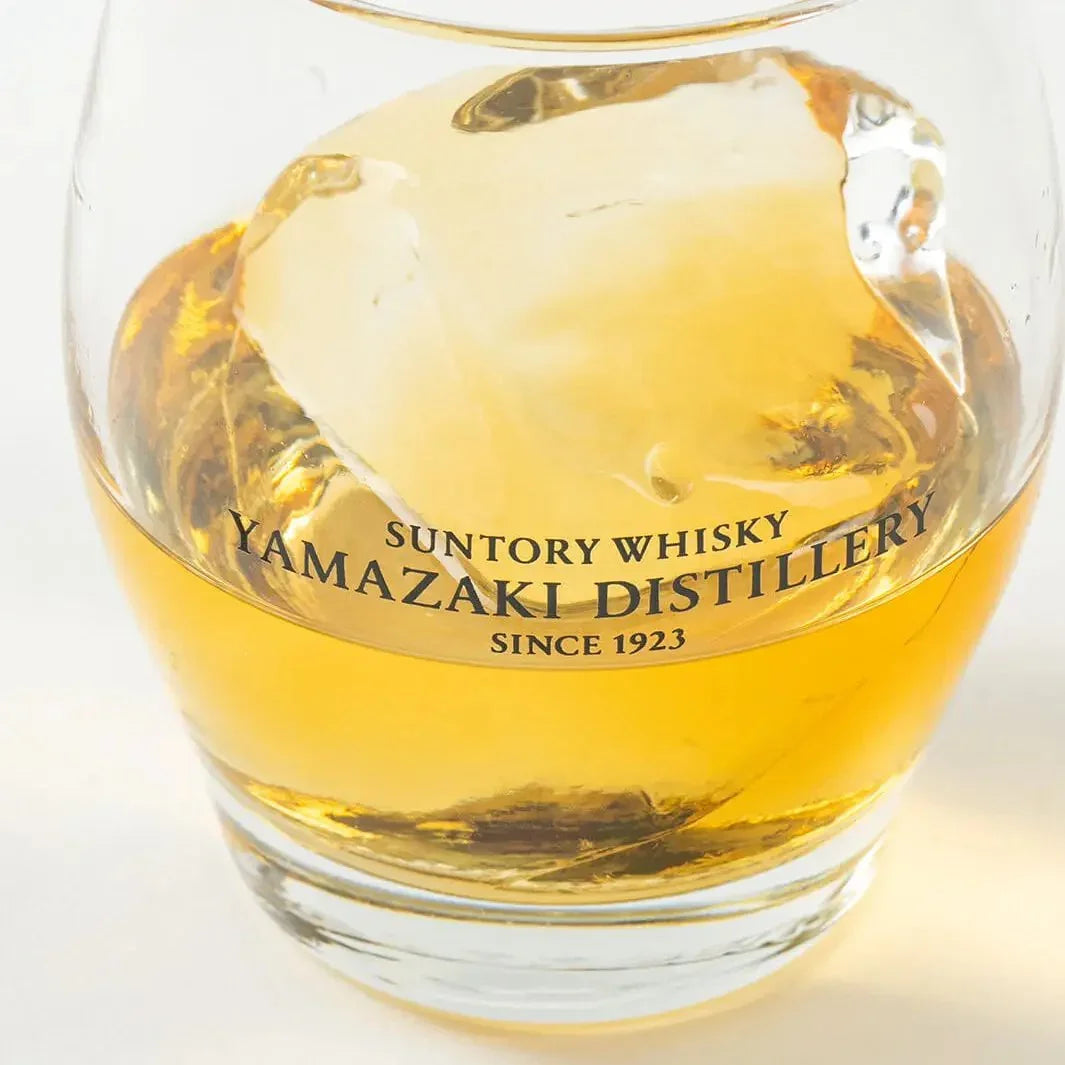 Close-up of Japanese Yamazaki whiskey glass with ice ball and whisky