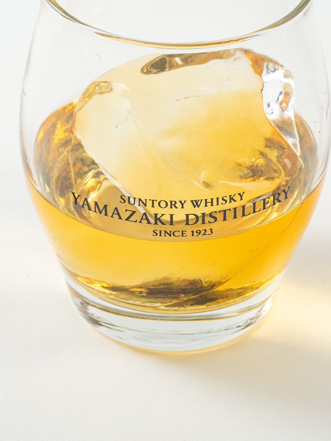 Close-up of Japanese Yamazaki whiskey glass with ice ball and whisky