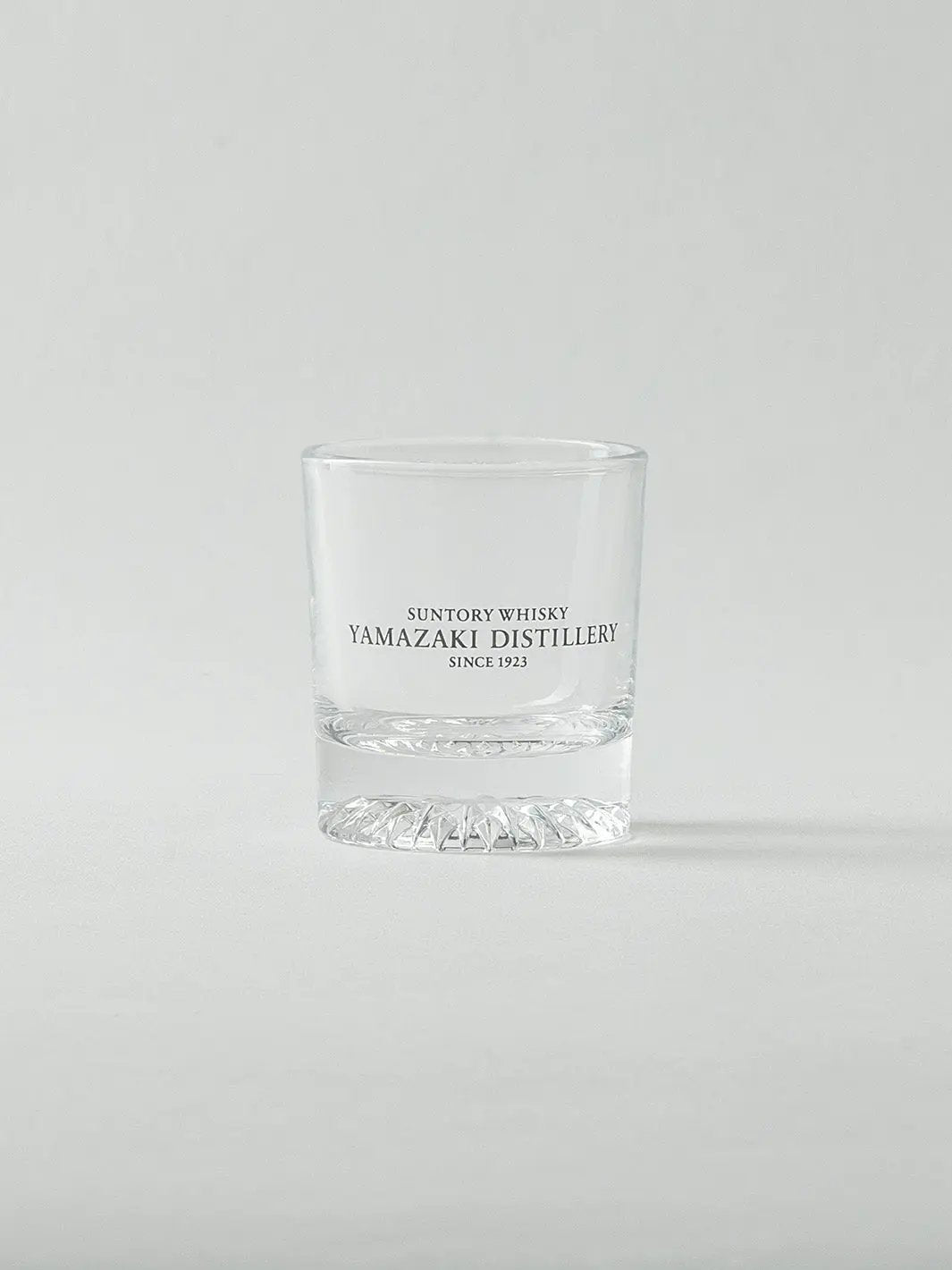 Empty Japanese whiskey shot glass from Yamazaki, front view