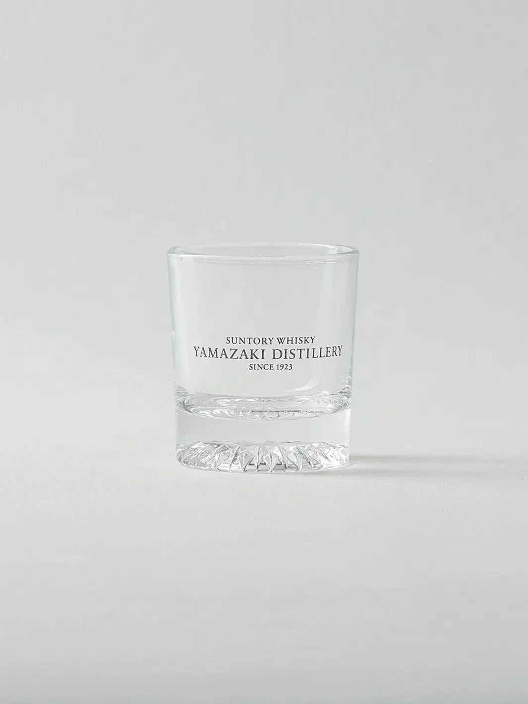 Empty Japanese whiskey shot glass from Yamazaki, front view