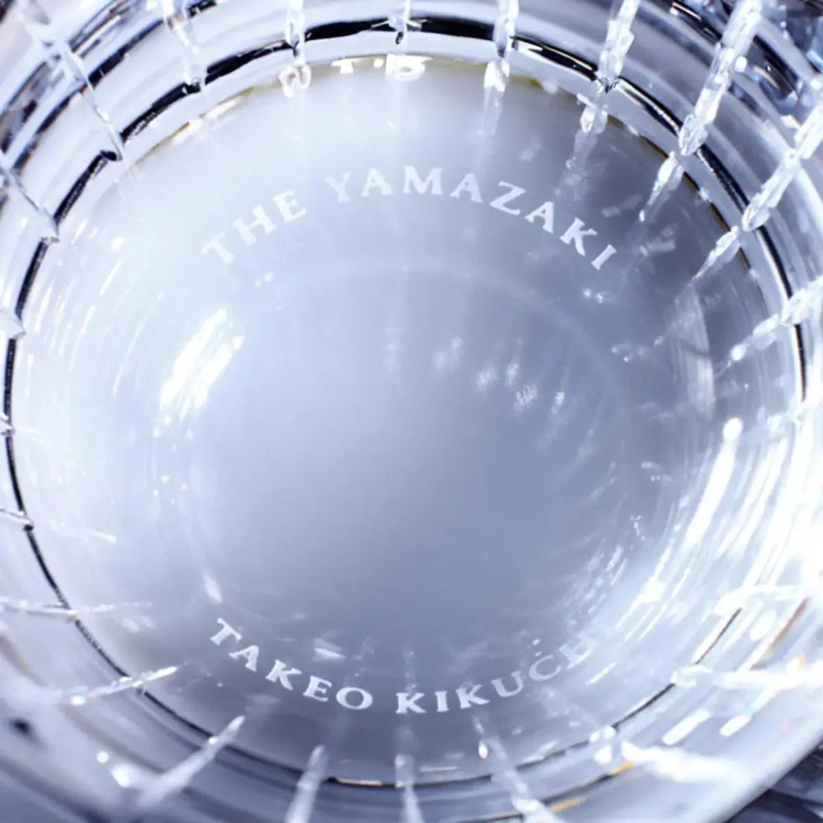 Bottom view of the Yamazaki × Takeo Kikuchi crystal rock glass, highlighting the intricate craftsmanship of the crystal base.