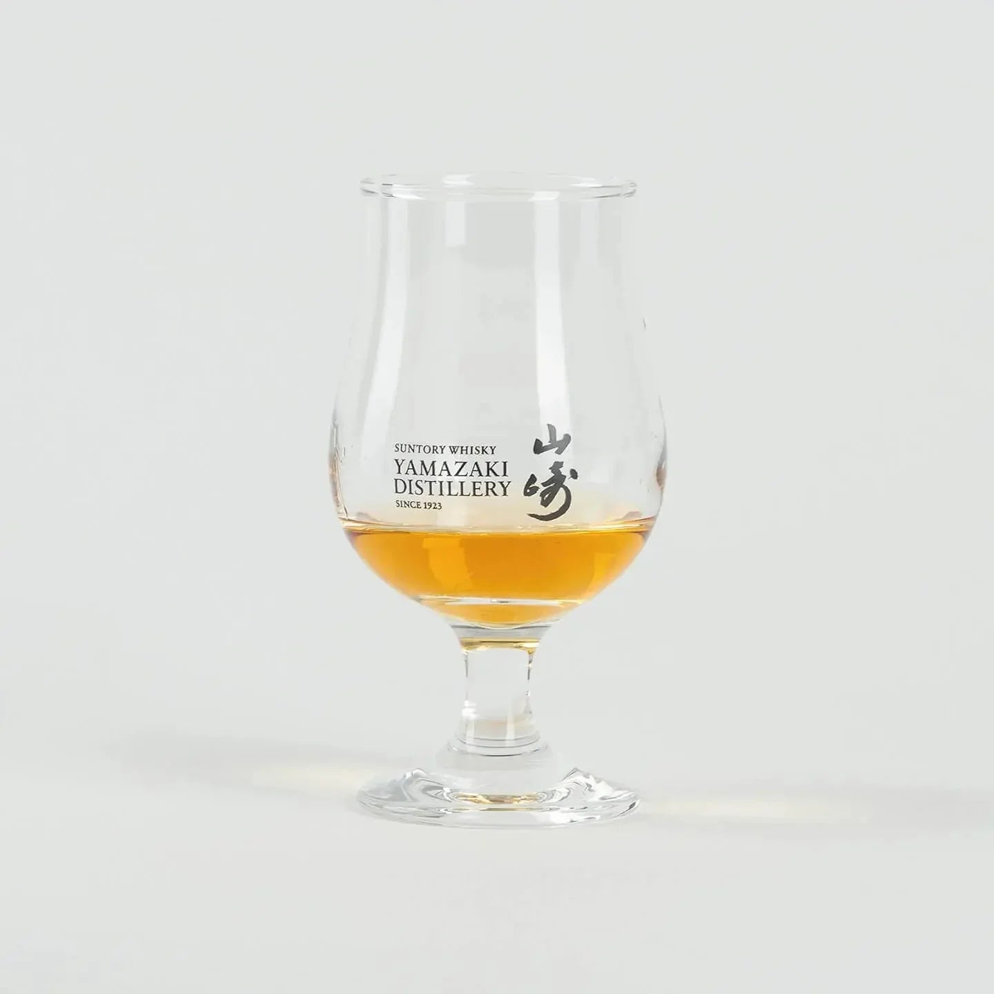 Yamazaki Japanese whiskey tasting glass with whisky, tulip-shaped