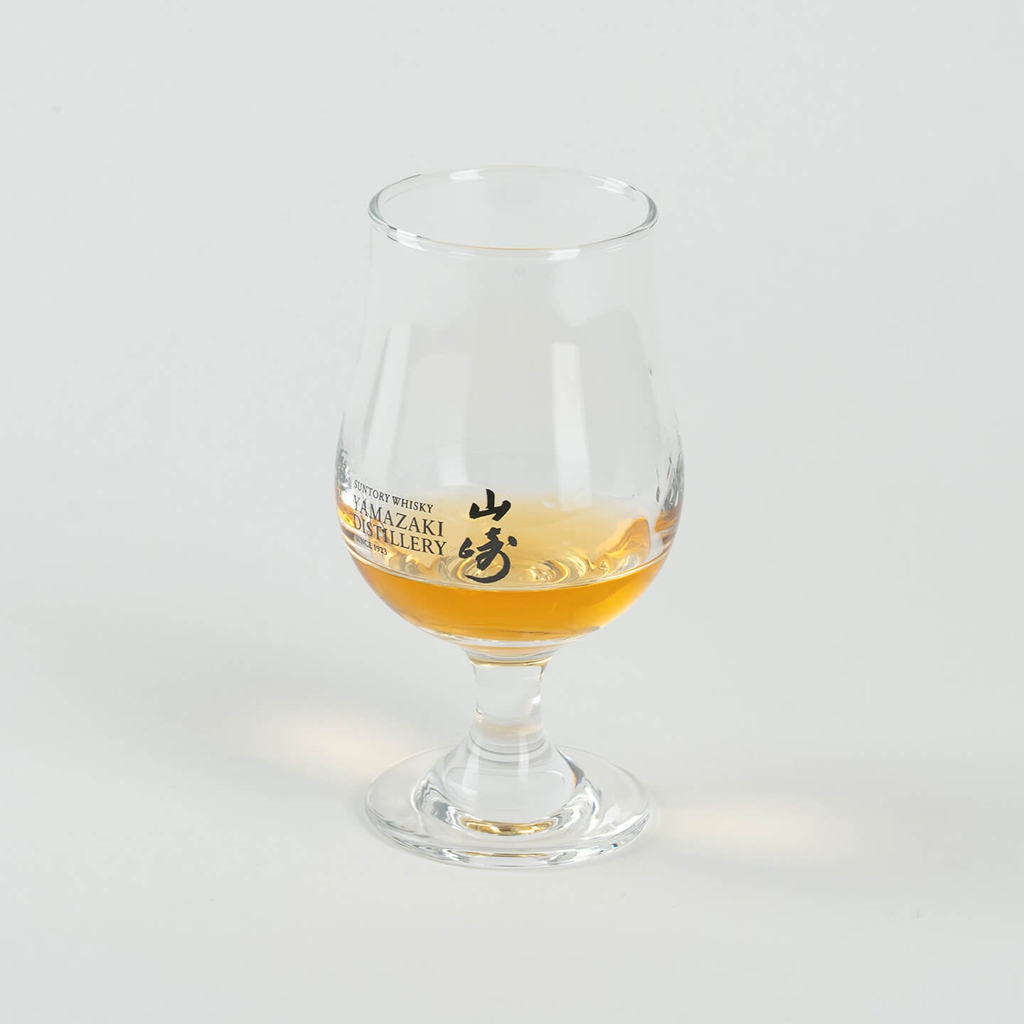 Angled view of Yamazaki whiskey tasting glass with whisky, limited edition