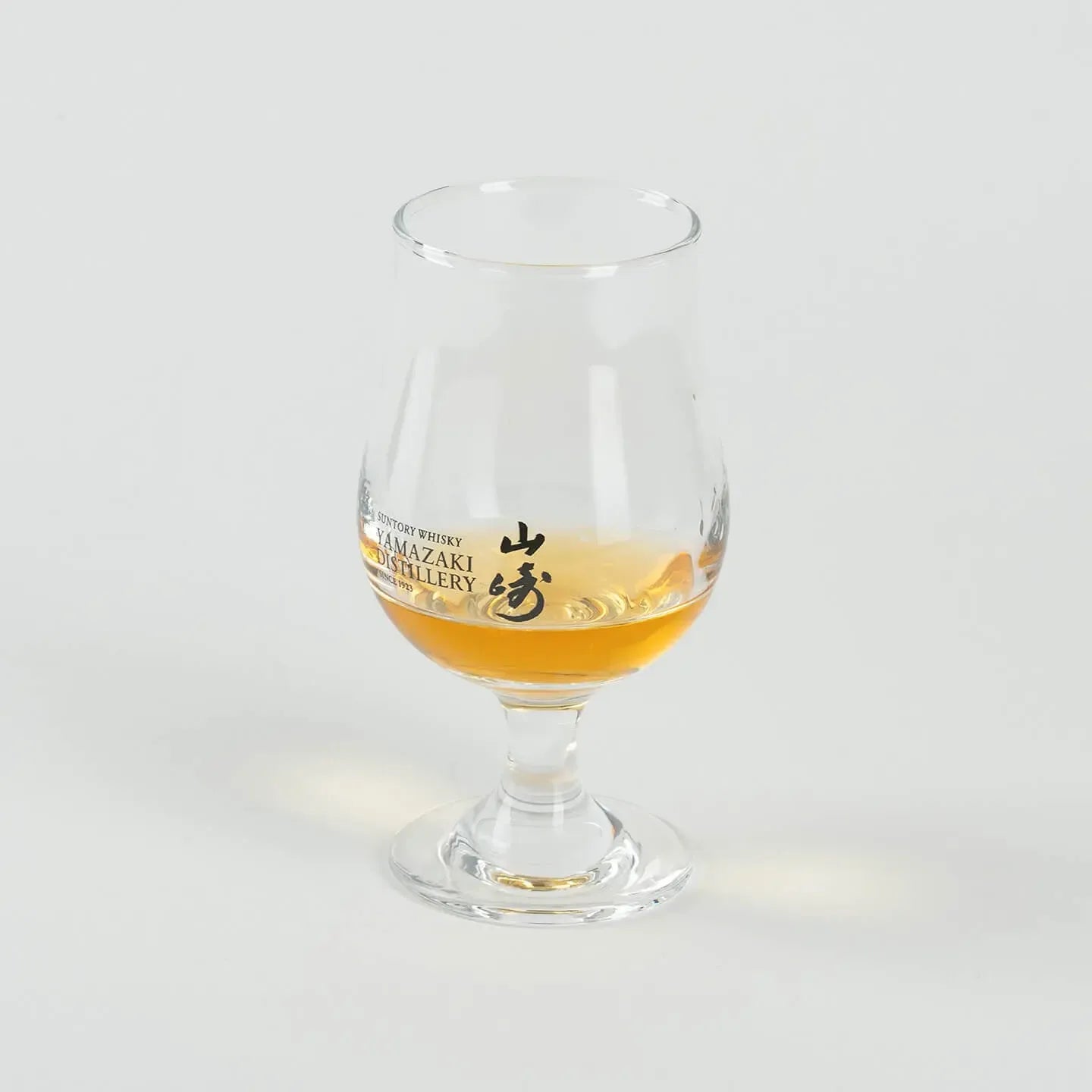 Angled view of Yamazaki whiskey tasting glass with whisky, limited edition