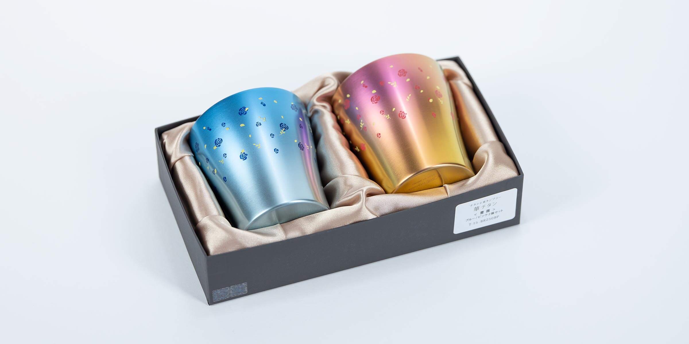 Angled view of the HORIE blue and pink titanium tumbler gift set