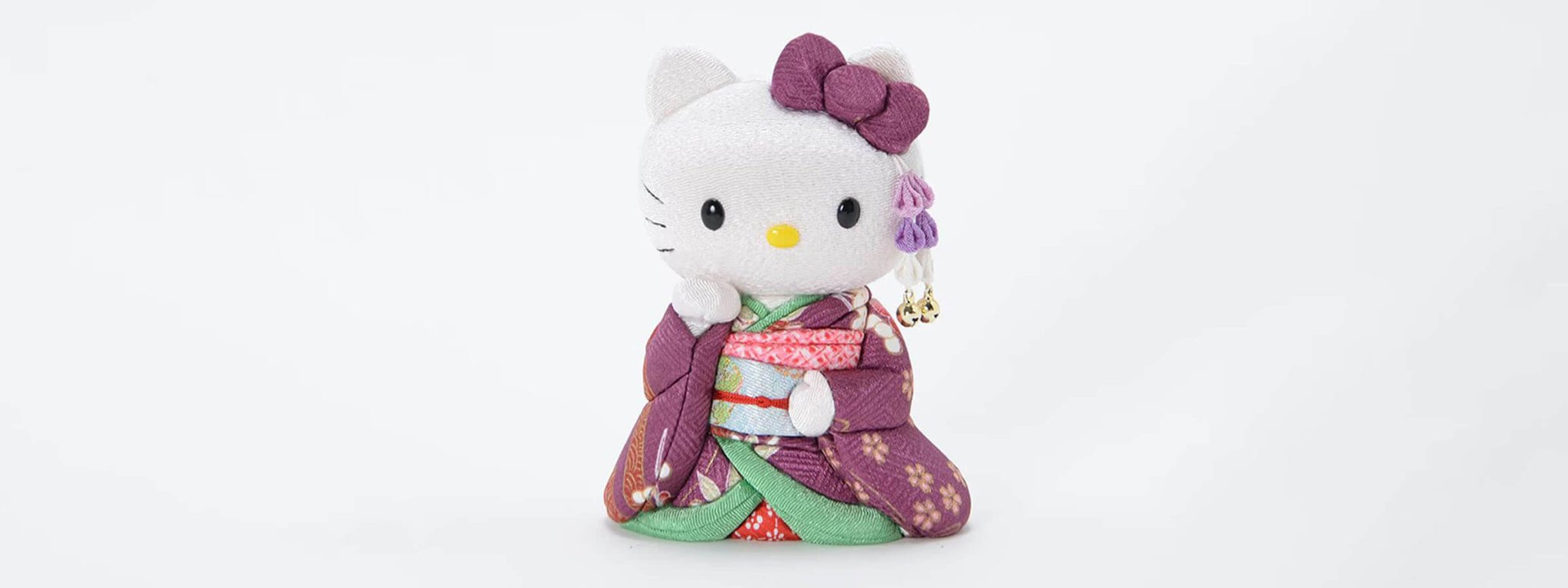 A handcrafted purple kimono Hello Kitty Kimekomi doll by Kakinuma Toko, featured as a unique luxury gift for her on the collection banner.