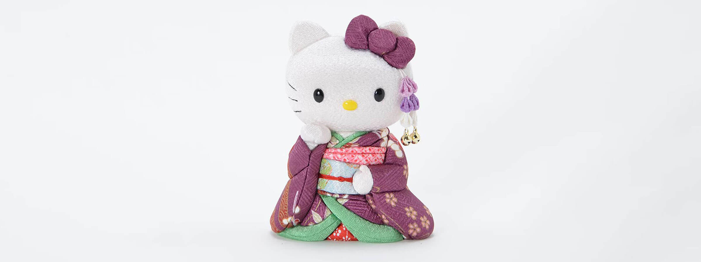 A handcrafted purple kimono Hello Kitty Kimekomi doll by Kakinuma Toko, featured as a unique luxury gift for her on the collection banner.
