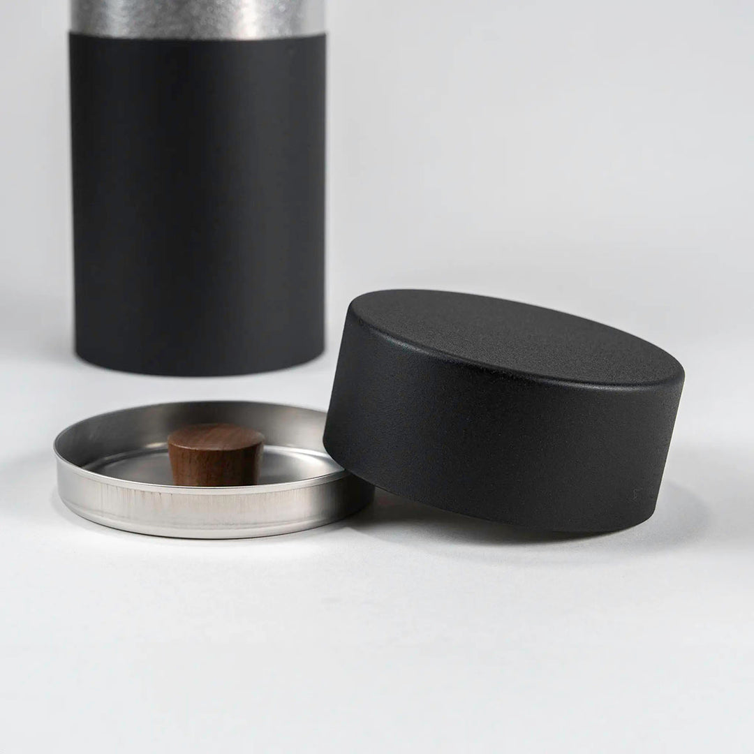 Close-up of the CHAKI Tea Canister - Black, highlighting the wood knob and lid detail