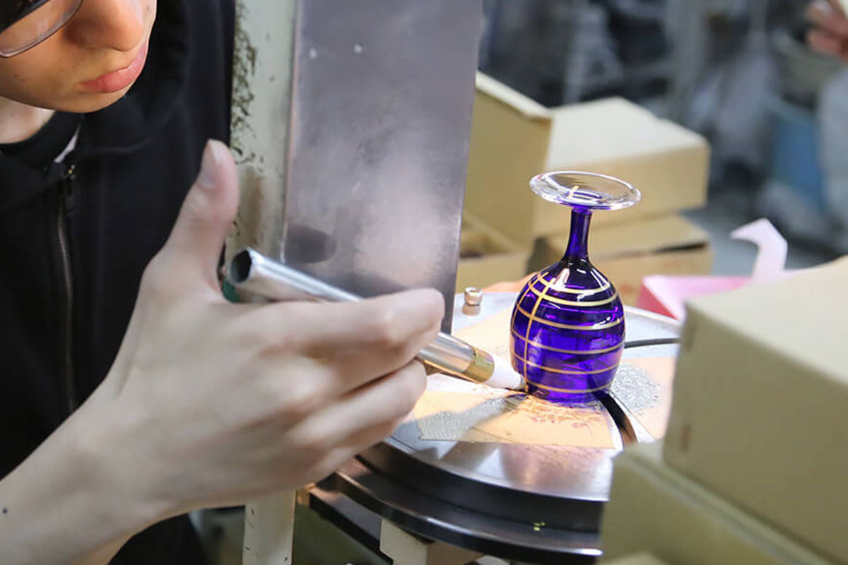 Edo Kiriko artisan marking layout on glass, drawing traditional geometric cutting pattern.