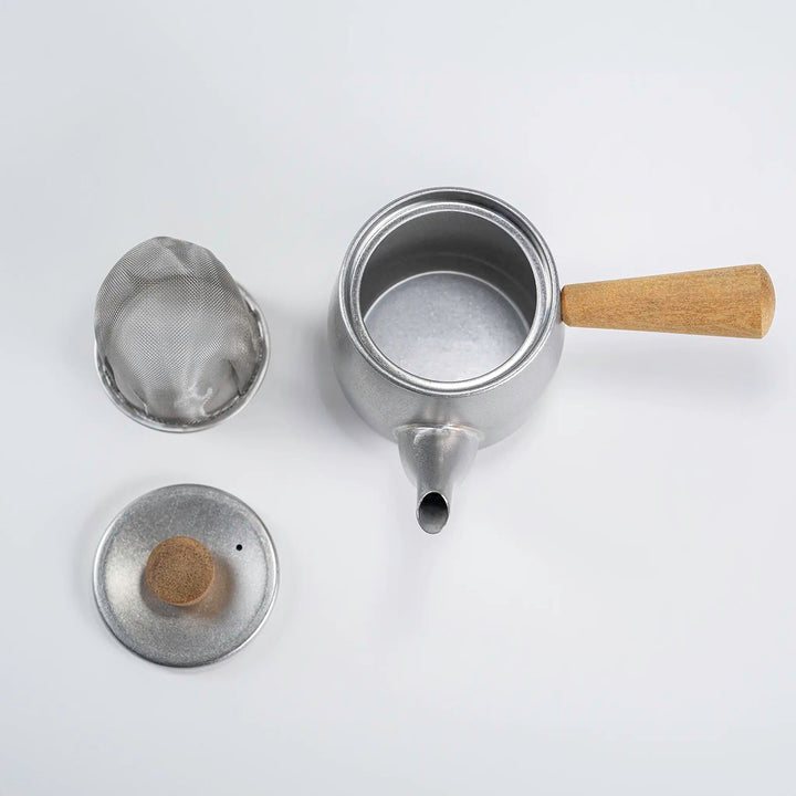 Top view of the teapot showing the natural wood knob and stainless steel lid