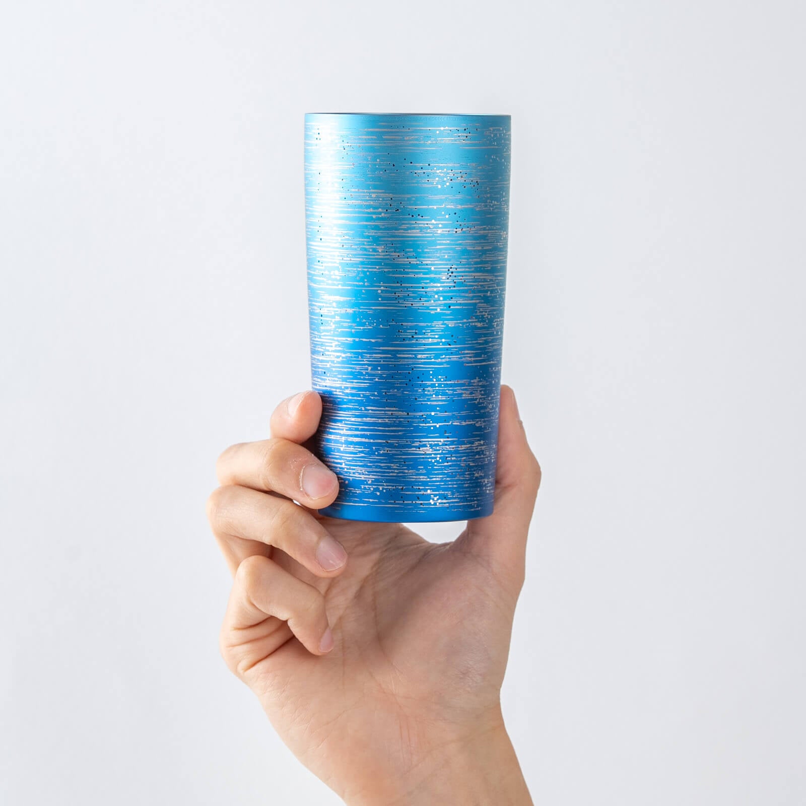 HORIE Ryo Ocean Blue titanium tumbler (350ml) held in hand, front view