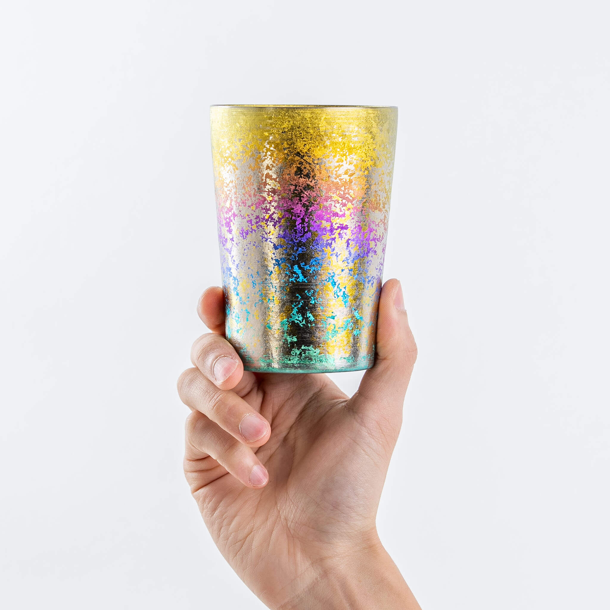 Hand holding a HORIE Taiko 400ml rainbow titanium tumbler