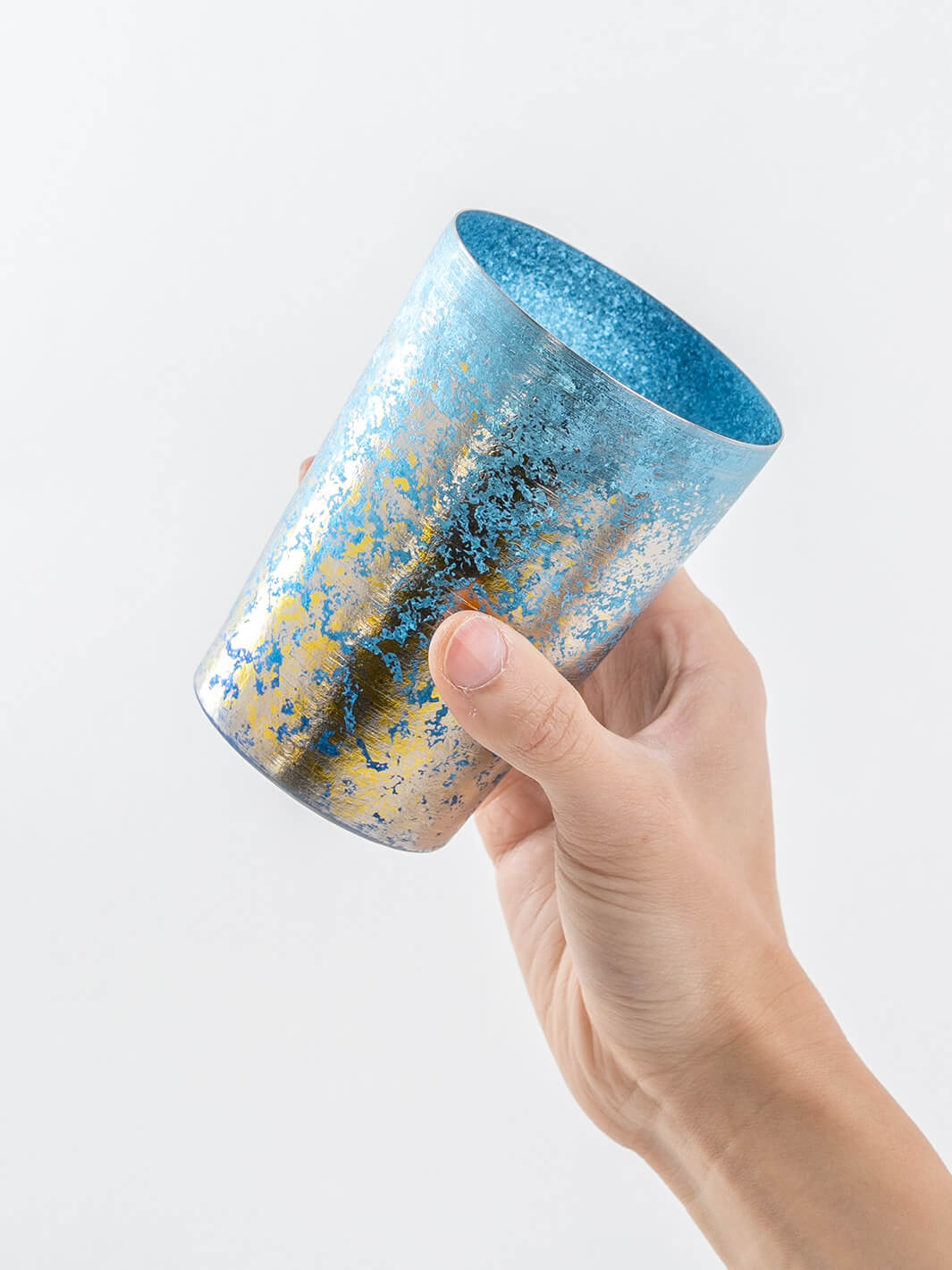 Blue HORIE tumbler held from side, textured finish