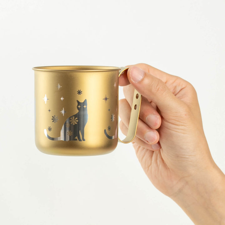 HORIE cat mug held in hand, front side