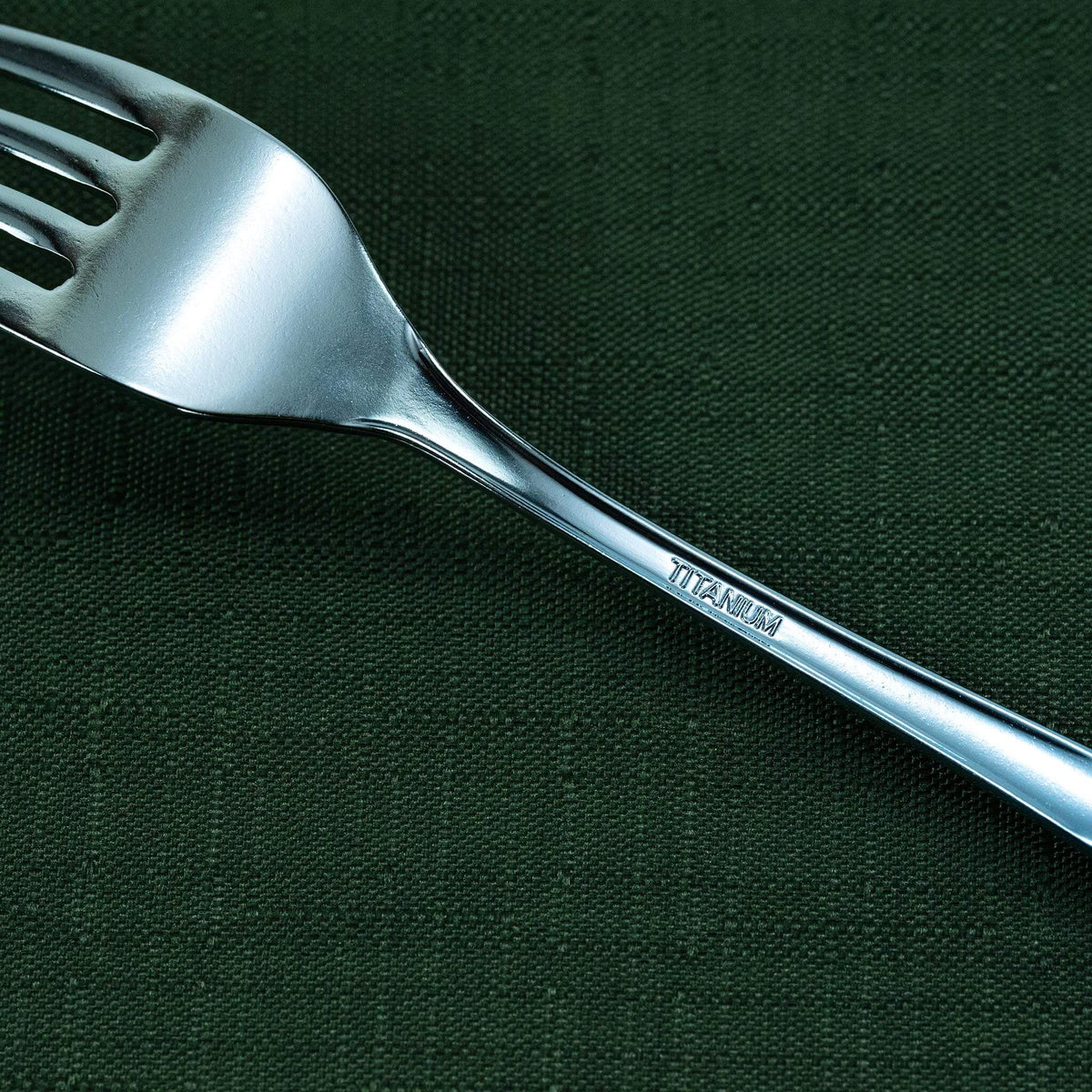 Close-up of the blue HORIE pure titanium dessert fork