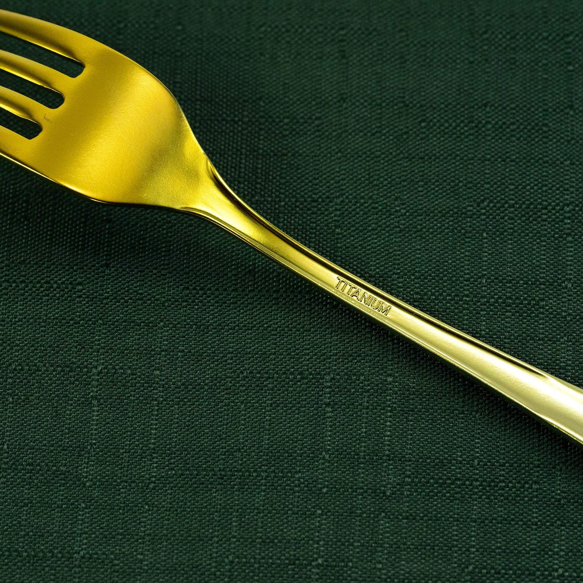 Close-up of the gold HORIE pure titanium dessert fork