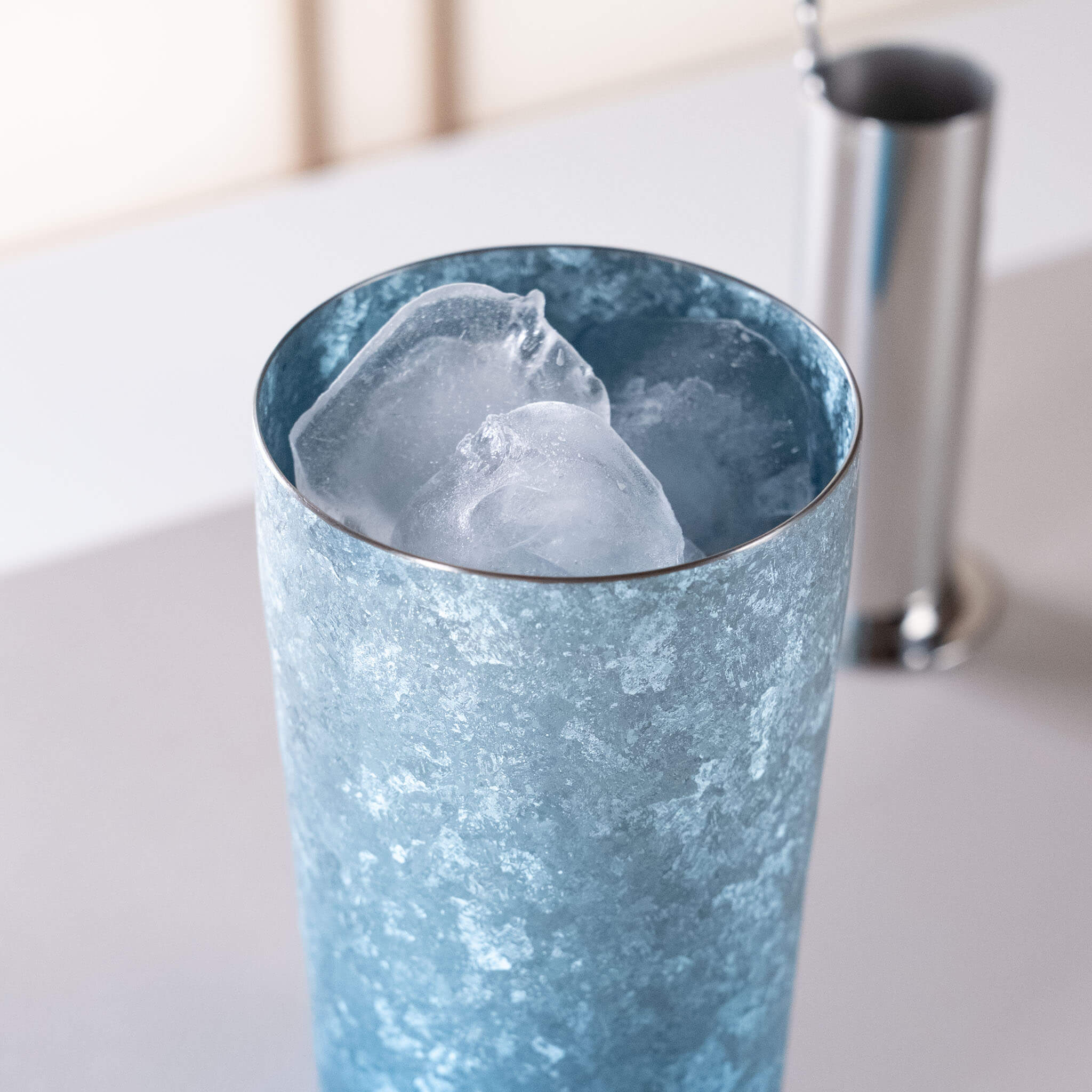 Top-down view of HORIE Titanium Kamazukuri 350ml Blue Tumbler filled with large ice cubes
