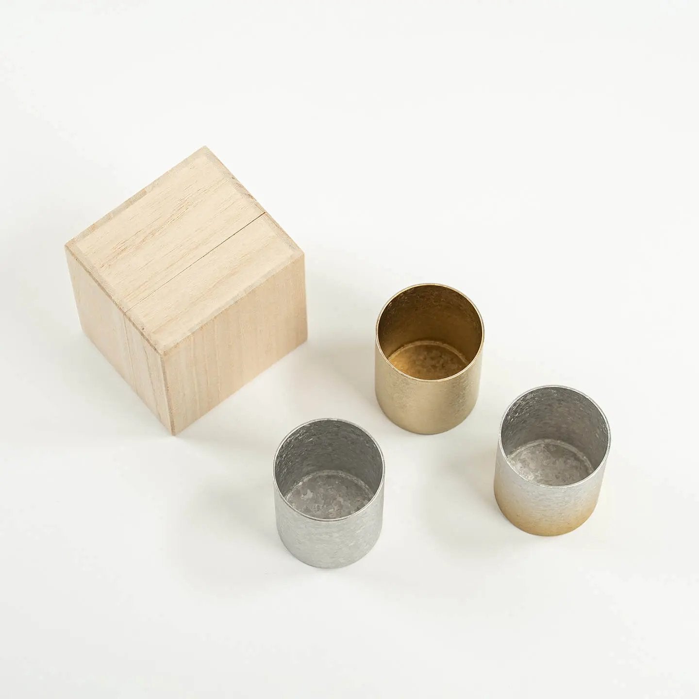 Top-down view showing the clean, pure titanium interiors of the HORIE Sake Cup trio.