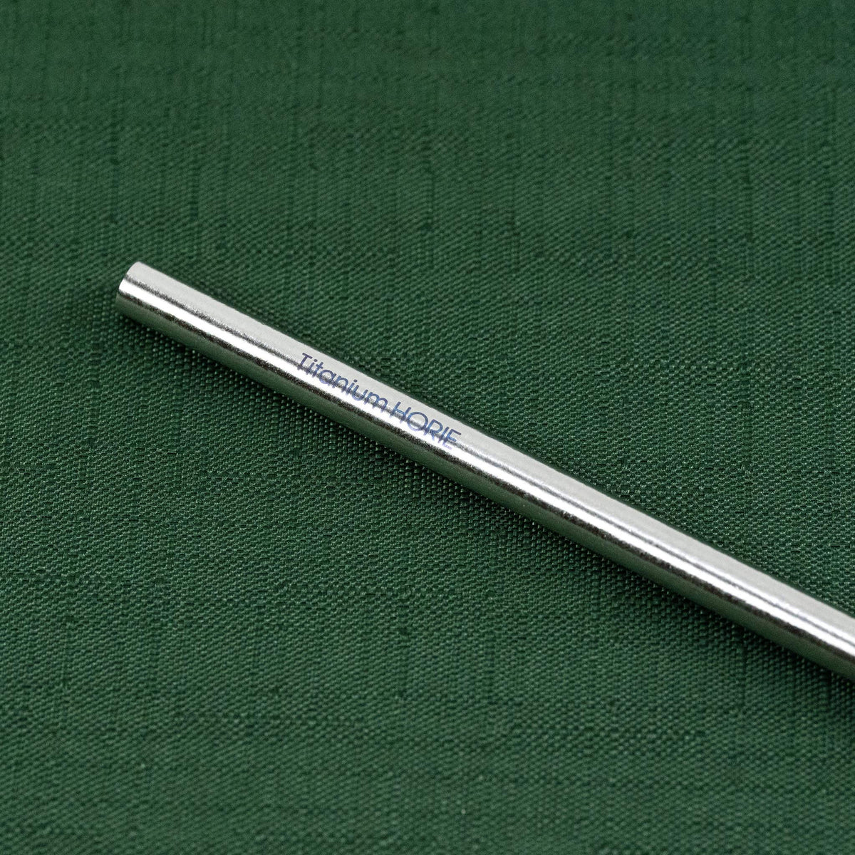 Close-up of the Titanium HORIE logo on the natural silver titanium straw