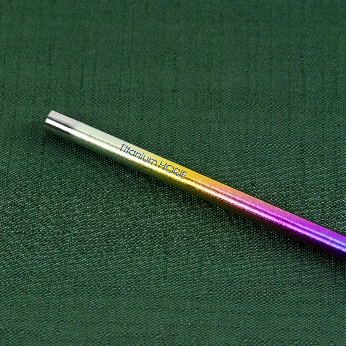 Close-up of the Titanium HORIE logo on the rainbow titanium straw