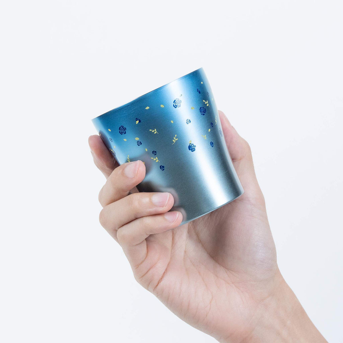 Hand holding the blue HORIE Hana Series 250ml titanium tumbler