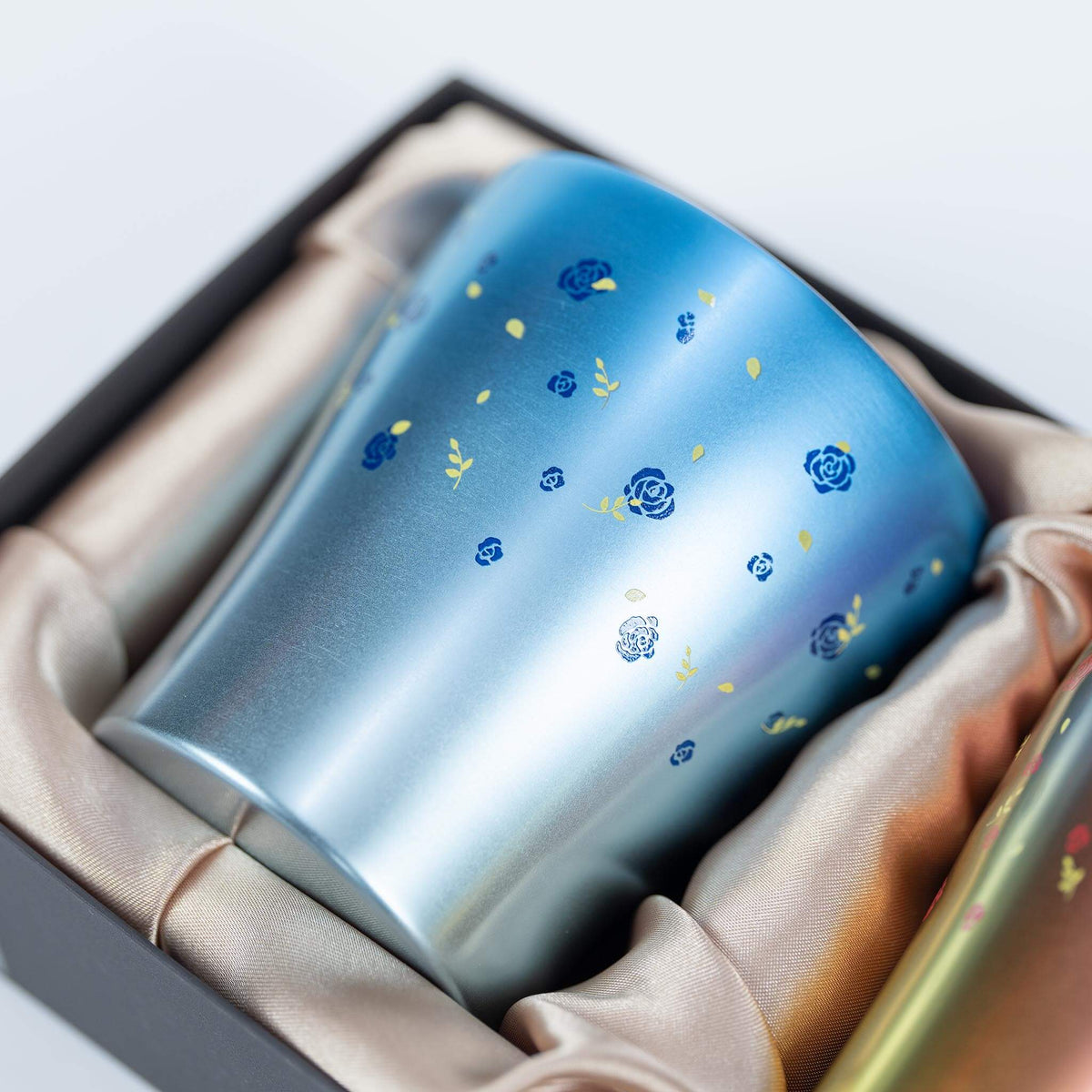 Close-up of the floral pattern on the blue HORIE Hana titanium tumbler