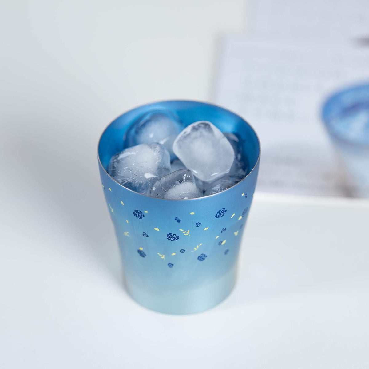 Blue HORIE Hana Series titanium tumbler filled with ice
